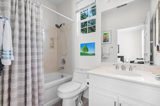 full bathroom featuring shower / bath combo with shower curtain, vanity, hardwood / wood-style floors, and toilet