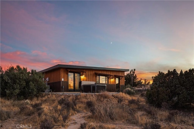 view of back house at dusk