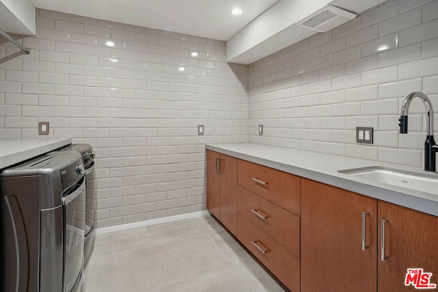 interior space with separate washer and dryer and sink