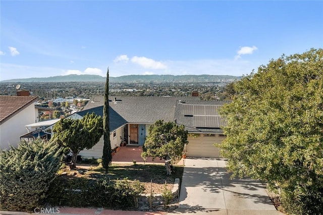 view of front of home with a mountain view and a garage