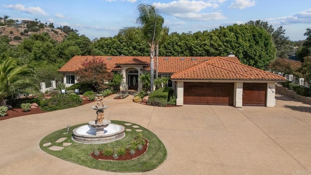 mediterranean / spanish-style house with a garage