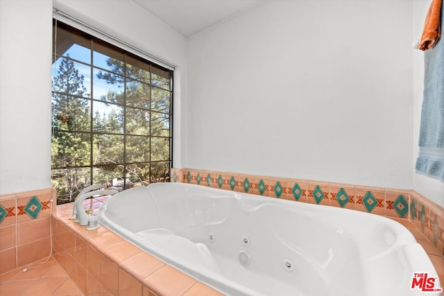 bathroom featuring tiled tub and tile patterned flooring