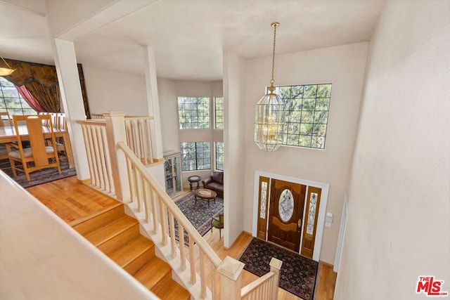 entryway featuring hardwood / wood-style flooring and an inviting chandelier