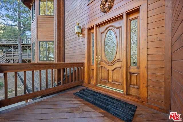 view of exterior entry with a porch