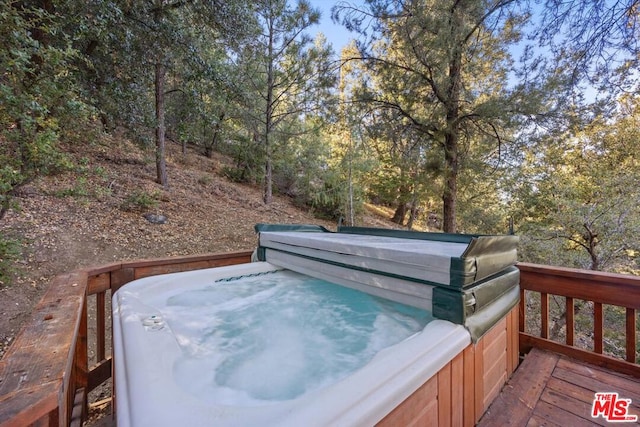 wooden deck with a hot tub