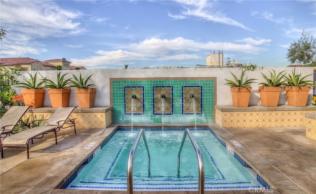 view of swimming pool with a hot tub