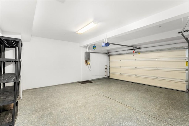 garage featuring electric panel and a garage door opener