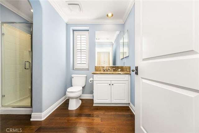 bathroom with vanity, wood-type flooring, a shower with shower door, and ornamental molding