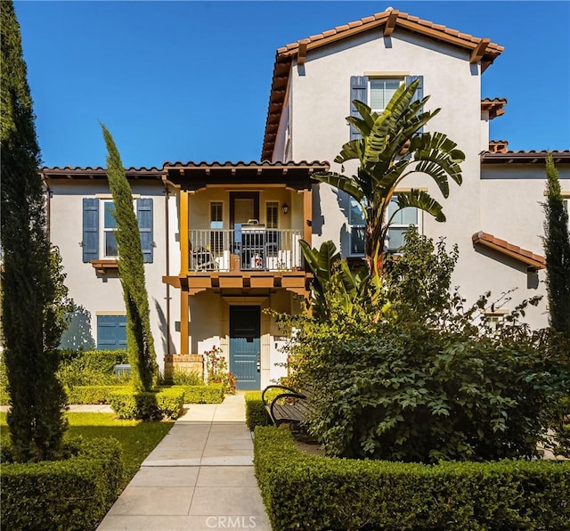 mediterranean / spanish-style home with a balcony