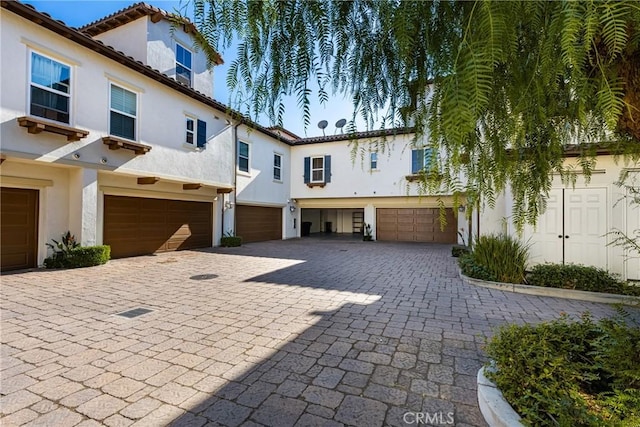 mediterranean / spanish-style house with a garage