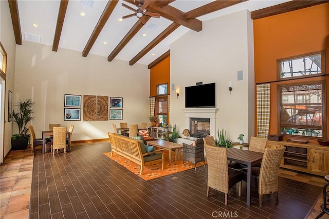 living room featuring beam ceiling, high vaulted ceiling, and ceiling fan