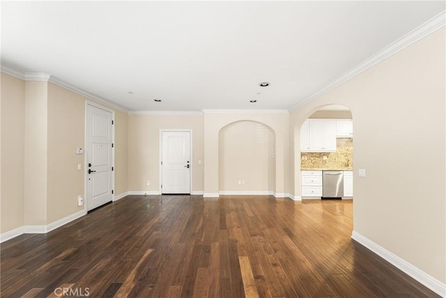 spare room with dark hardwood / wood-style flooring and crown molding