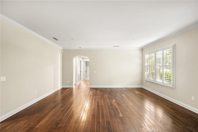 empty room featuring dark hardwood / wood-style flooring and ornamental molding