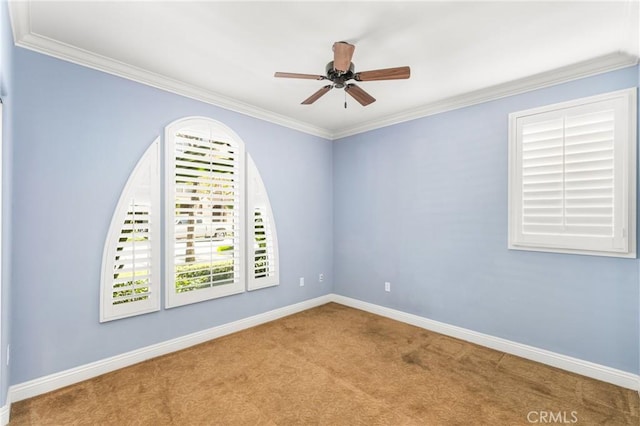 spare room with ceiling fan, light colored carpet, and ornamental molding