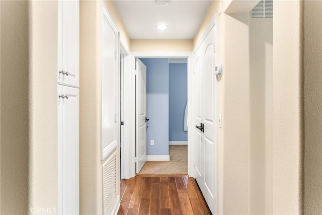 hall with dark hardwood / wood-style flooring