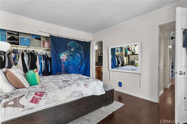 bedroom with a closet, dark hardwood / wood-style floors, and ornamental molding