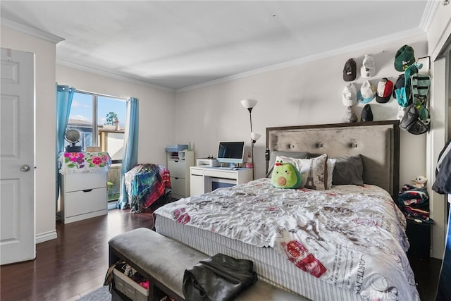 bedroom with dark hardwood / wood-style floors and crown molding