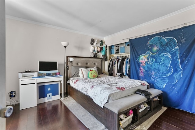 bedroom with ornamental molding, a closet, and dark wood-type flooring