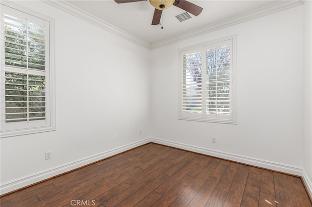 spare room with ornamental molding, dark hardwood / wood-style flooring, and a healthy amount of sunlight