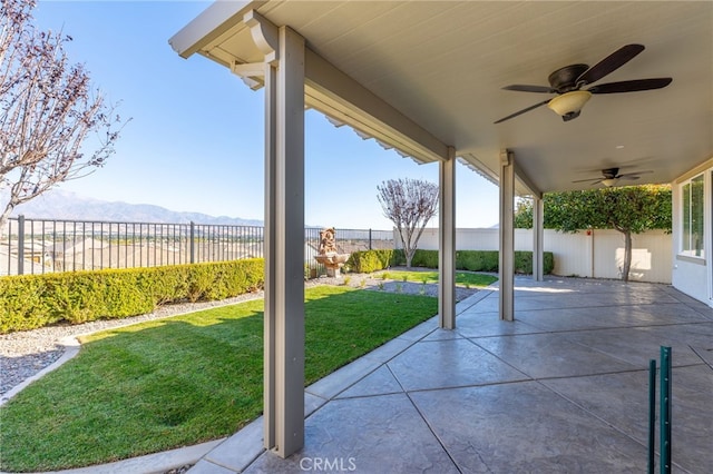 view of patio featuring a mountain view and ceiling fan