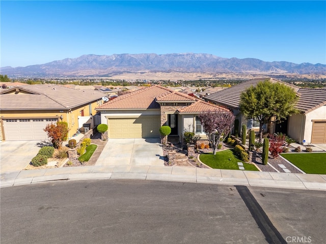 view of front of home featuring a mountain view and a garage