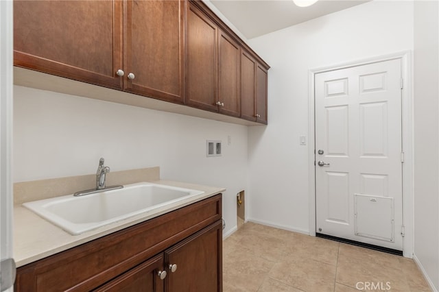 laundry room with cabinets, hookup for a washing machine, light tile patterned floors, and sink