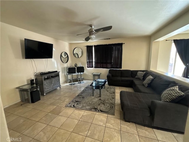 living room featuring ceiling fan and light tile patterned floors