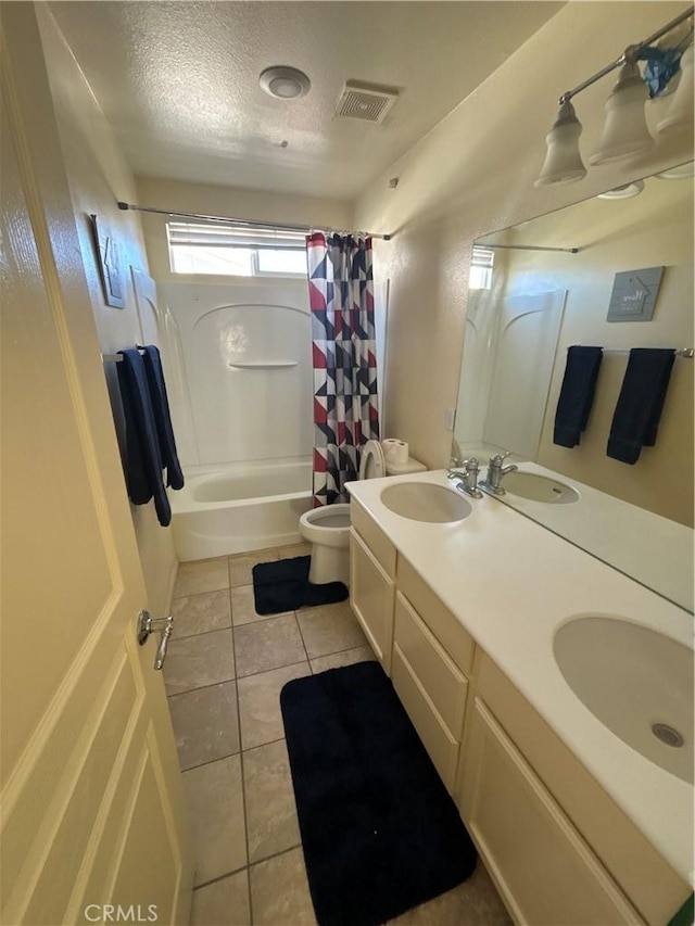 full bathroom with tile patterned floors, vanity, a textured ceiling, shower / bath combo with shower curtain, and toilet