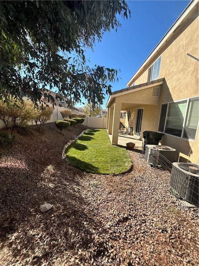 view of yard featuring a patio and central AC unit