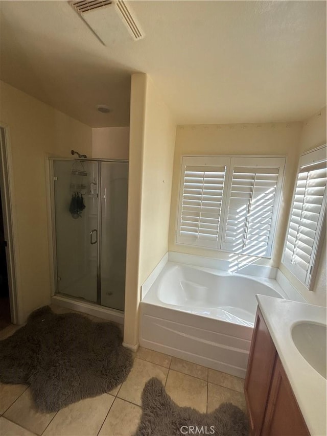 bathroom featuring vanity, tile patterned floors, and separate shower and tub