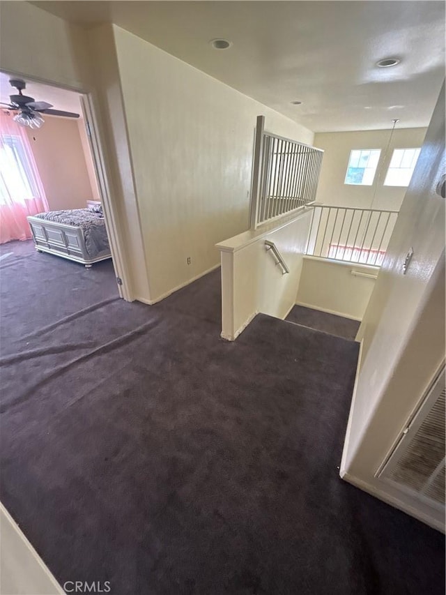 interior space with carpet flooring, ceiling fan, and a wealth of natural light