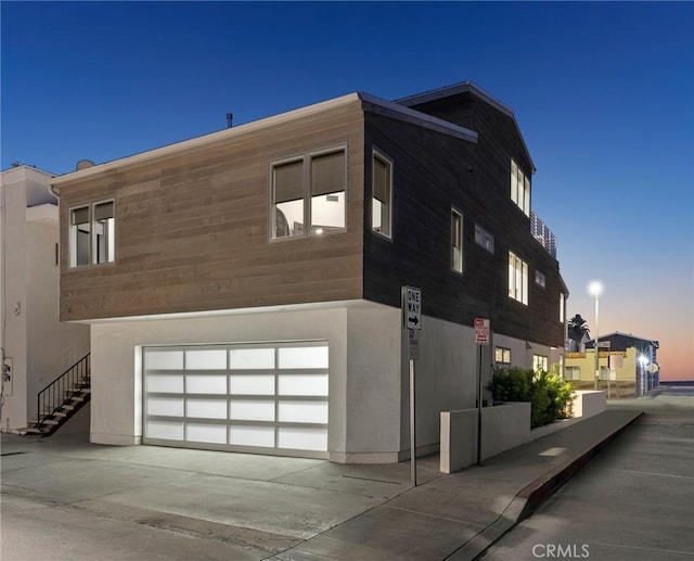 property exterior at dusk with a garage