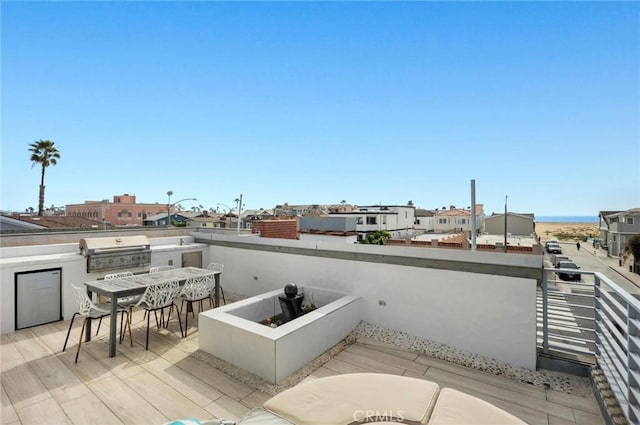 view of patio / terrace with area for grilling and a balcony