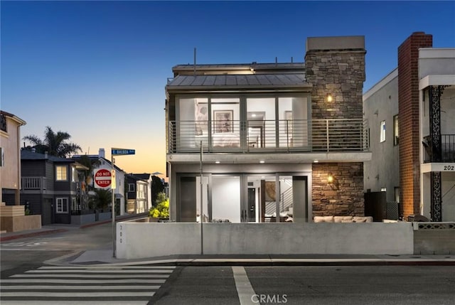 view of front of home with a balcony