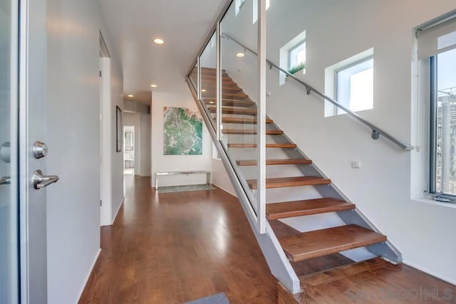 stairs featuring wood-type flooring