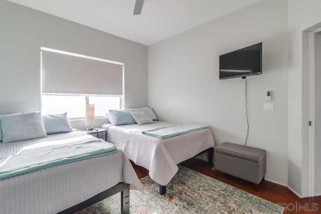 bedroom with ceiling fan and dark hardwood / wood-style floors