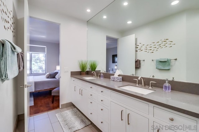 bathroom featuring tile patterned flooring and vanity