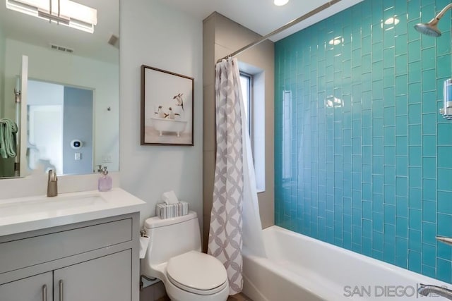 full bathroom with vanity, toilet, and shower / bath combo with shower curtain