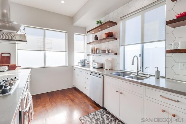 kitchen with white dishwasher, white cabinetry, sink, and tasteful backsplash