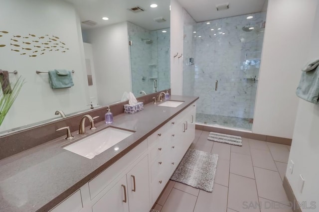 bathroom with tile patterned floors, vanity, and walk in shower