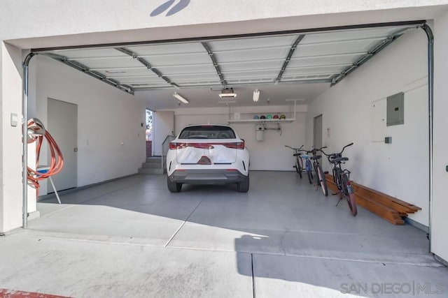 garage with electric panel and a garage door opener