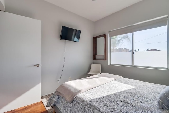 bedroom with hardwood / wood-style floors