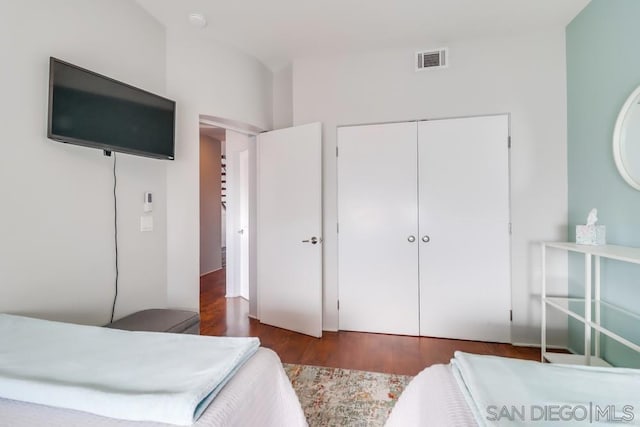 bedroom featuring a closet and dark wood-type flooring