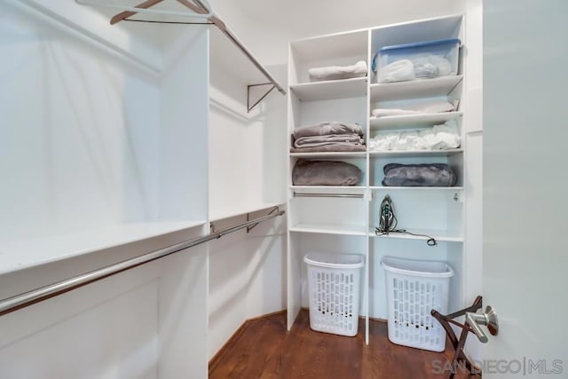 spacious closet with dark hardwood / wood-style floors