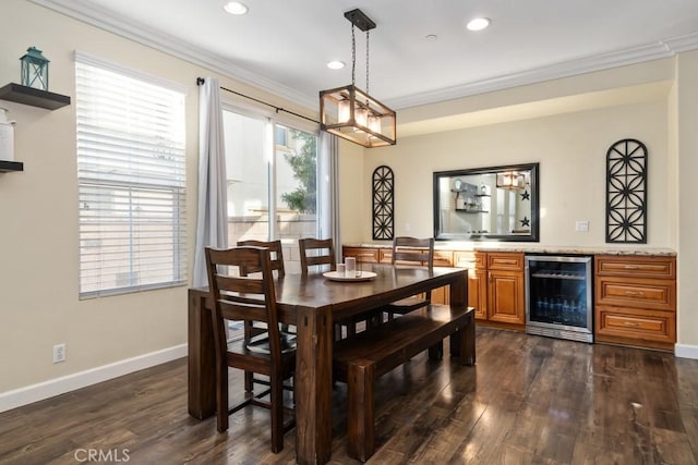 dining room featuring dark wood-type flooring, ornamental molding, and beverage cooler