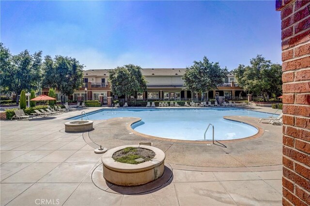 view of swimming pool with a patio