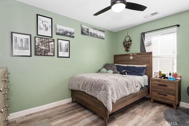 bedroom with hardwood / wood-style flooring and ceiling fan