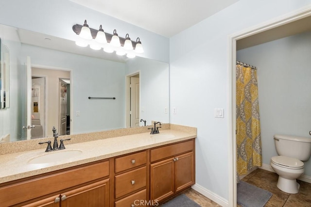 bathroom with vanity, tile patterned flooring, and toilet