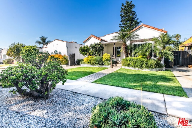 mediterranean / spanish-style house featuring a front lawn