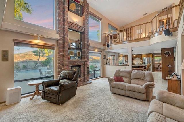 carpeted living room featuring a wealth of natural light and a high ceiling